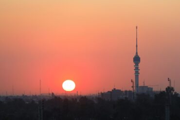 Die Sonne geht hinter der Skyline von Bagdad unter.