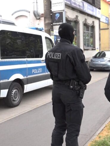 Polizeibeamte vor einem der durchsuchten Objekte in Braunschweig.