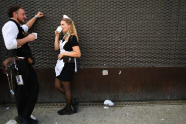 Kleine Pause für die Wiesn-Bewirtung: Bedienung Christina und Kellner Cedric  hinter dem Schottenhamel Festzelt auf dem Oktoberfest.