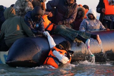 Menschen drängen sich an Bord eines kleinen Bootes vor der Küste von Dünkirchen in Frankreich, während sie versuchen den Ärmelkanal nach Großbritannien zu überqueren.