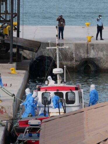 Gesundheitspersonal in Schutzkleidung evakuiert Patienten vom Kreuzfahrtschiff «Hondius» in einem Hafen.