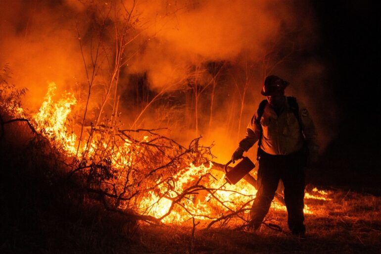 Ein Feuerwehrmann kämpft gegen die Flammen