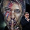 Der deutsche Außenminister Johann Wadephul (CDU) steht bei einem Rundgang durch das Stadtzentrum von Buenos Aires neben einem Graffiti von David Bowie.